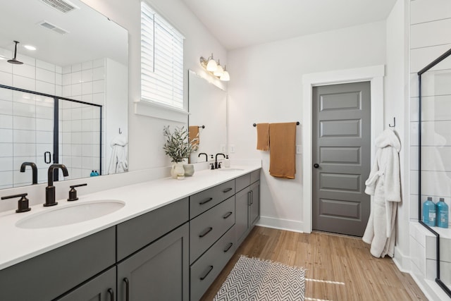643 Blueway Ave, Summerville, SC 29486 - bathroom with a shower stall, wood finished floors, visible vents, and a sink