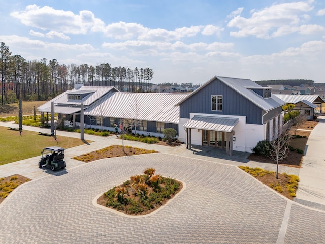 643 Blueway Ave, Summerville, SC 29486 - modern farmhouse featuring a standing seam roof, curved driveway, and metal roof