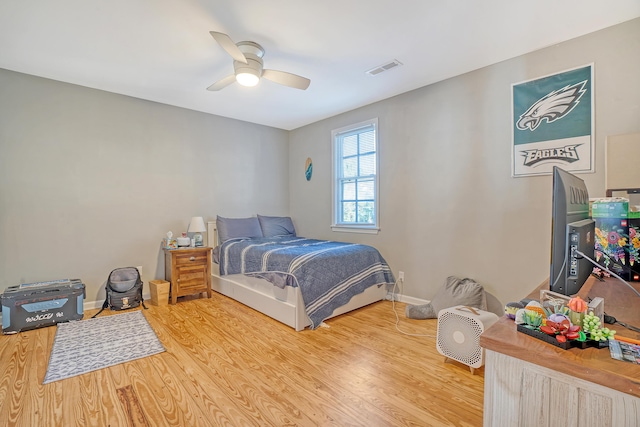 bedroom with hardwood / wood-style floors and ceiling fan