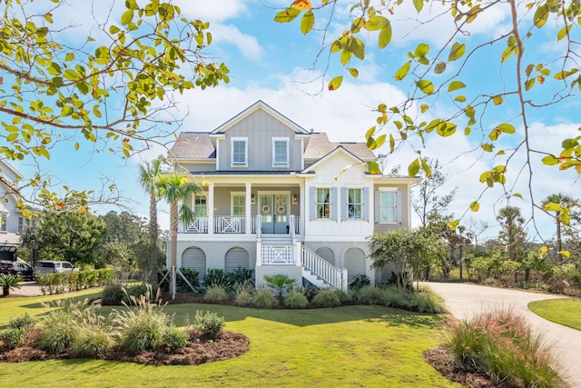 view of front of home featuring covered porch and a front lawn