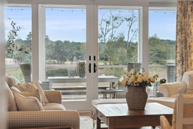 sunroom featuring a water view