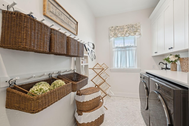 washroom with independent washer and dryer, cabinets, and light tile patterned floors