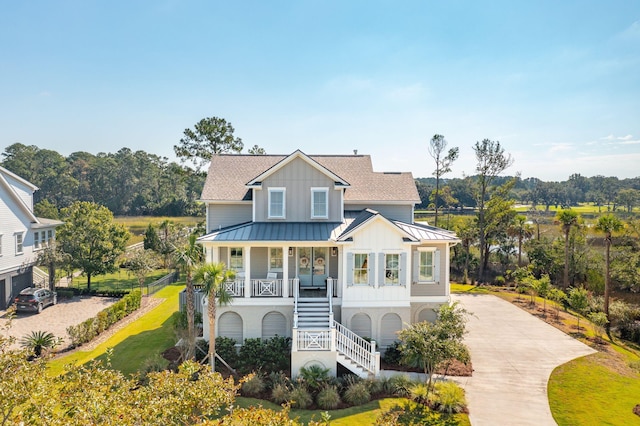 view of front of house with a porch and a front lawn