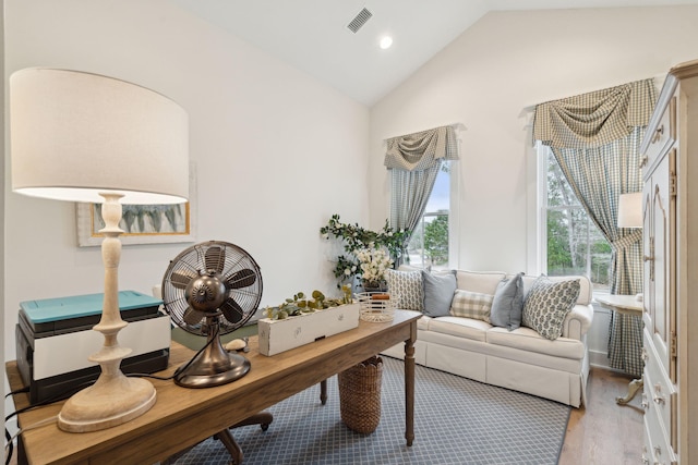 sitting room with vaulted ceiling and light hardwood / wood-style flooring