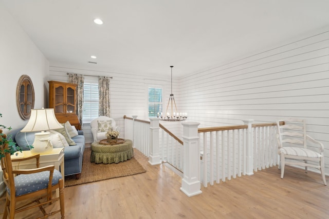 living area featuring a chandelier and light hardwood / wood-style floors