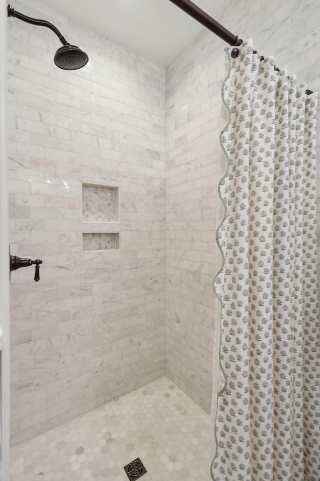 bathroom with tiled shower