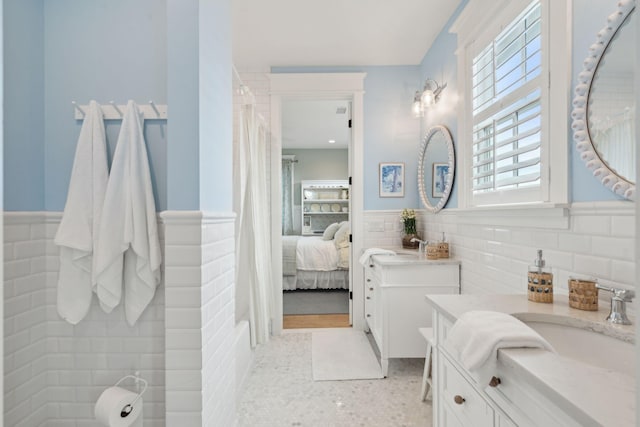 bathroom with tile walls, vanity, and a shower with curtain