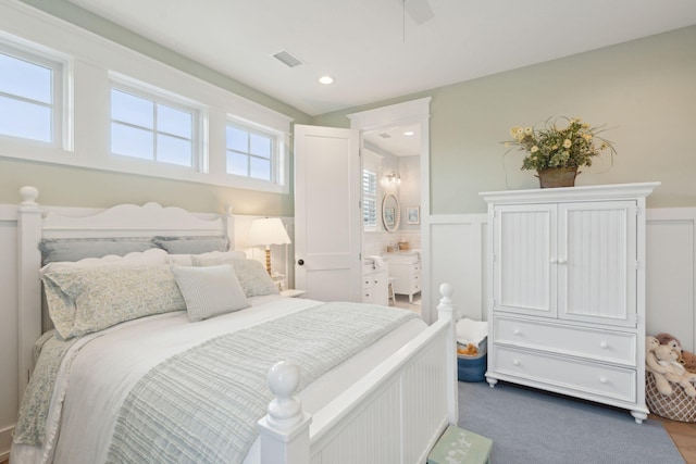 bedroom with ceiling fan and ensuite bath