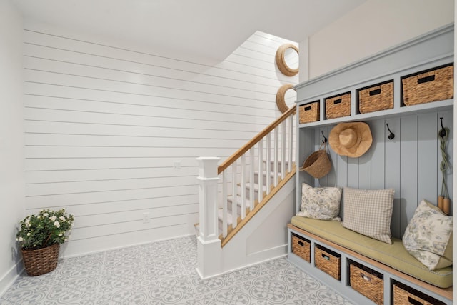 mudroom featuring wooden walls