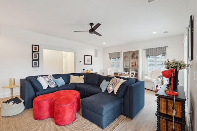 living room with ceiling fan and light hardwood / wood-style floors