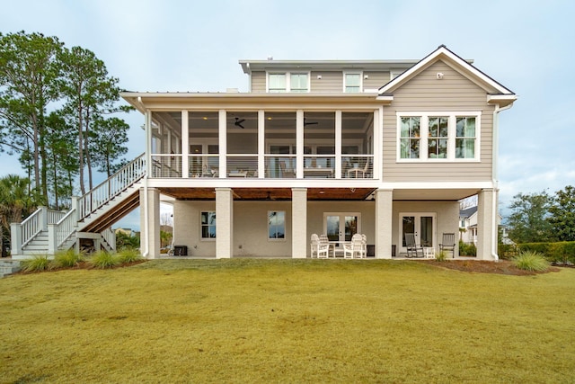 back of house featuring a sunroom, a yard, ceiling fan, and a patio area