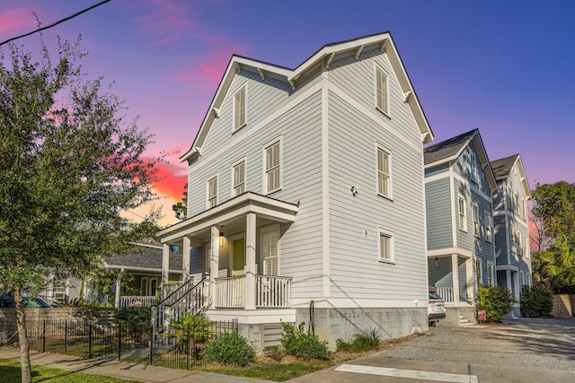 property exterior at dusk with covered porch