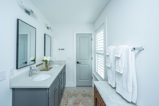 bathroom featuring tile patterned flooring, vanity, and plenty of natural light