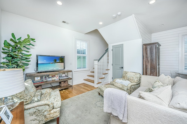 living room featuring hardwood / wood-style flooring and lofted ceiling