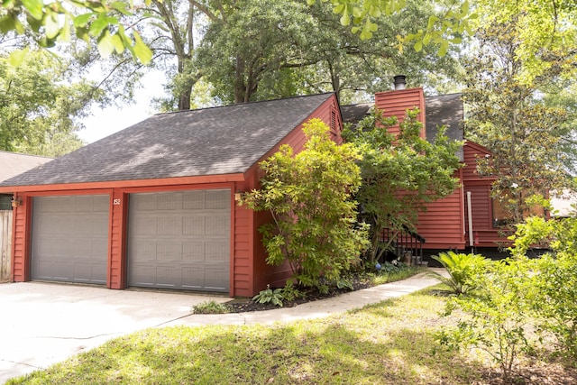 152 Mansfield Blvd, Charleston, SC 29418 - view of front of property featuring roof with shingles, a garage, an outdoor structure, and a chimney