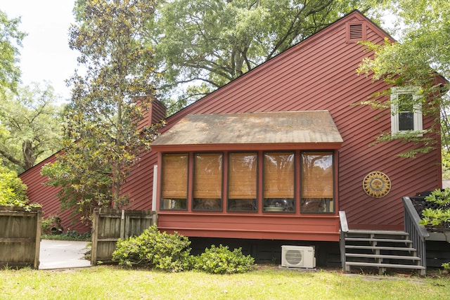 152 Mansfield Blvd, Charleston, SC 29418 - back of house with a cooling unit, a chimney, a lawn, and a sunroom