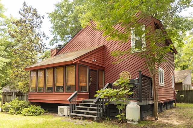 152 Mansfield Blvd, Charleston, SC 29418 - back of house with a sunroom, a cooling unit, and a chimney