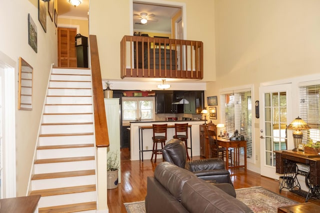 152 Mansfield Blvd, Charleston, SC 29418 - living room featuring wood finished floors, stairs, crown molding, a ceiling fan, and a towering ceiling