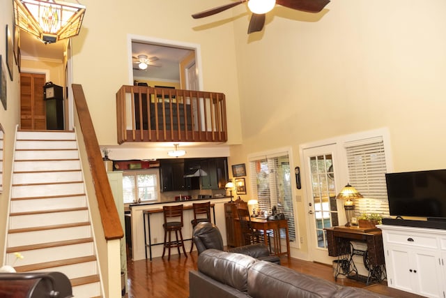 152 Mansfield Blvd, Charleston, SC 29418 - living area with dark wood-type flooring, a ceiling fan, stairs, and a towering ceiling