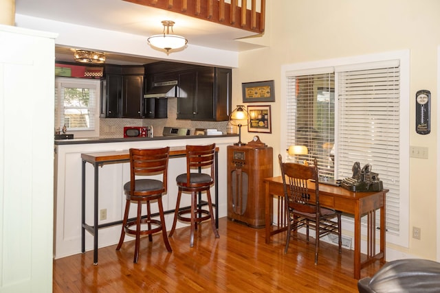 152 Mansfield Blvd, Charleston, SC 29418 - bar featuring wood finished floors, tasteful backsplash, and under cabinet range hood