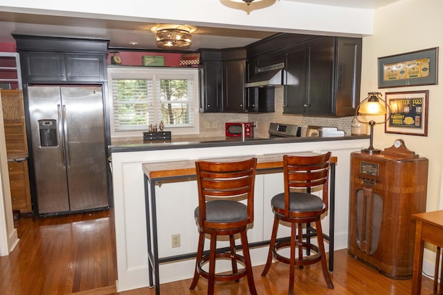 152 Mansfield Blvd, Charleston, SC 29418 - kitchen with stainless steel appliances, under cabinet range hood, tasteful backsplash, and dark wood-style flooring