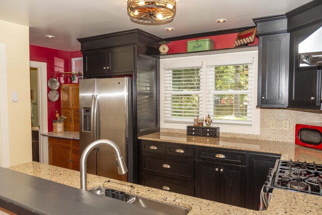 152 Mansfield Blvd, Charleston, SC 29418 - kitchen with appliances with stainless steel finishes, a sink, backsplash, light stone countertops, and exhaust hood