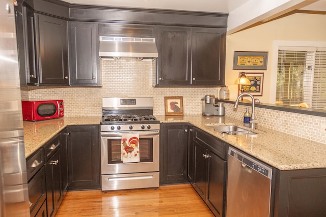 152 Mansfield Blvd, Charleston, SC 29418 - kitchen featuring appliances with stainless steel finishes, extractor fan, a peninsula, a sink, and light wood-style floors