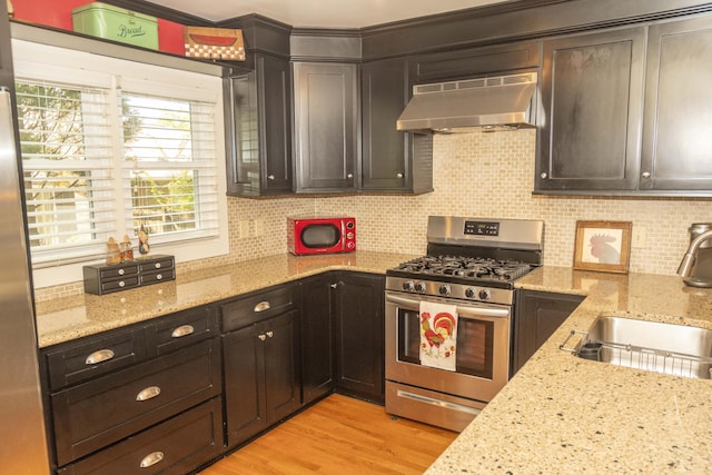 152 Mansfield Blvd, Charleston, SC 29418 - kitchen featuring extractor fan, stainless steel appliances, a sink, backsplash, and light wood-style floors