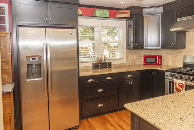 152 Mansfield Blvd, Charleston, SC 29418 - kitchen featuring stainless steel appliances, under cabinet range hood, light stone counters, and light wood-style floors