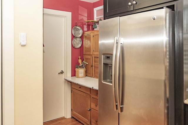 152 Mansfield Blvd, Charleston, SC 29418 - kitchen featuring stainless steel fridge, light countertops, light wood-type flooring, and brown cabinetry