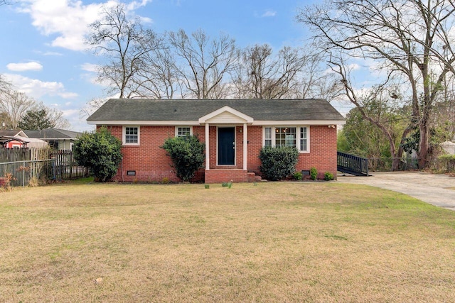 view of front of house with brick siding, a front lawn, fence, crawl space, and driveway