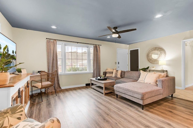 living area with recessed lighting, light wood-type flooring, baseboards, and a ceiling fan