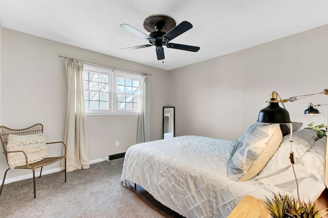 bedroom featuring baseboards, carpet floors, a textured ceiling, and a ceiling fan