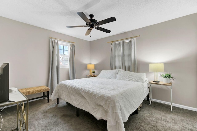 carpeted bedroom with a textured ceiling, baseboards, and a ceiling fan