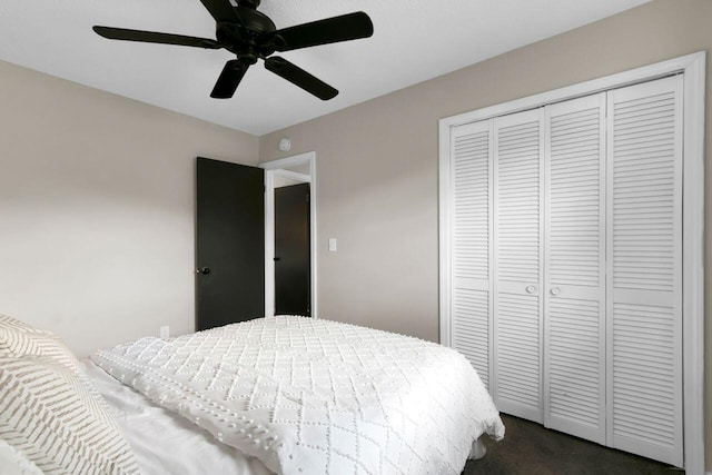 bedroom featuring a closet, a ceiling fan, and dark carpet