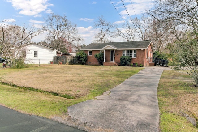 view of front facade featuring fence, a front lawn, crawl space, aphalt driveway, and brick siding