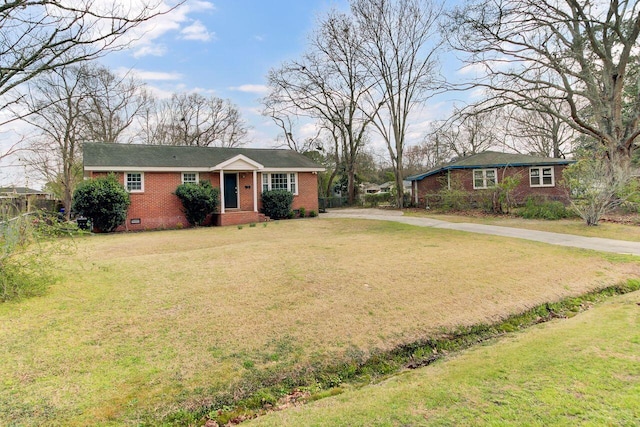 ranch-style home with a front yard, fence, brick siding, and crawl space