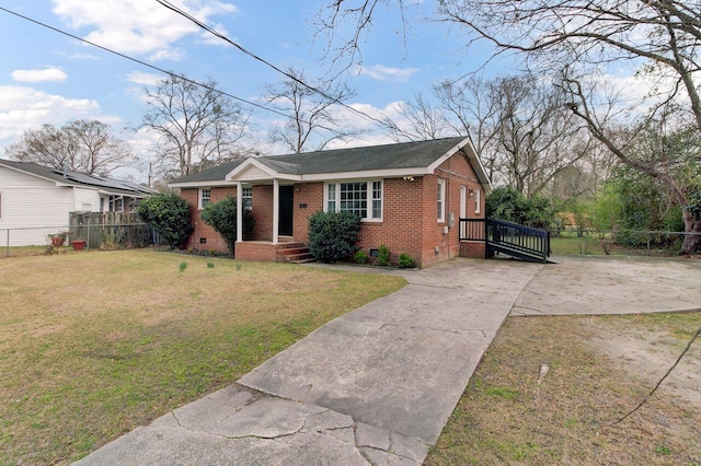 view of front of home featuring a front yard, fence, driveway, crawl space, and brick siding