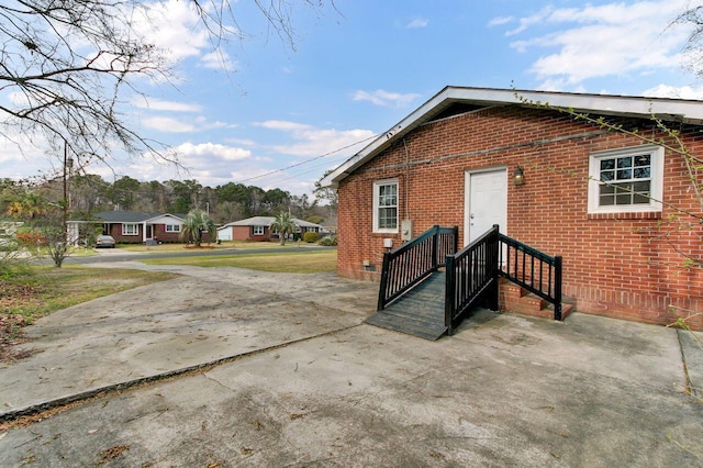 exterior space with brick siding and crawl space