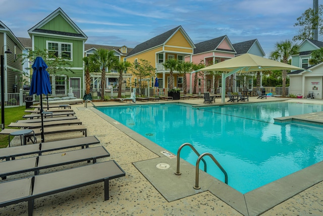 community pool featuring a patio area and fence