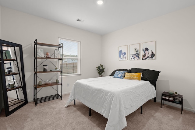 bedroom featuring light carpet