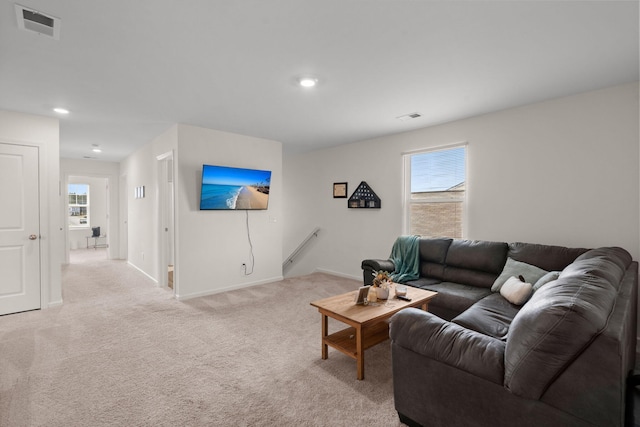 living room featuring light carpet and plenty of natural light