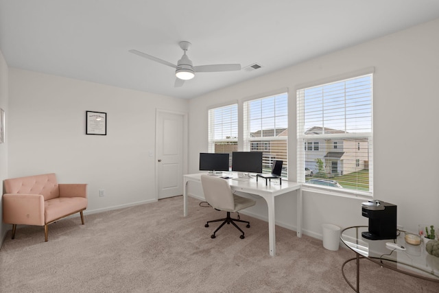 carpeted office with ceiling fan and a wealth of natural light