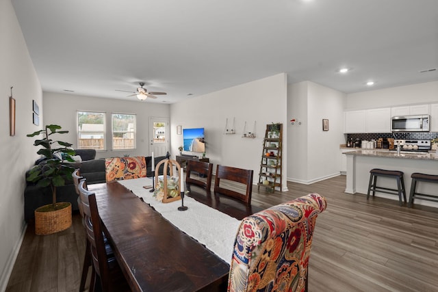 dining space featuring ceiling fan and wood-type flooring