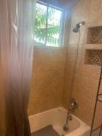 bathroom featuring shower / tub combo with curtain