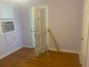 unfurnished bedroom with dark hardwood / wood-style floors