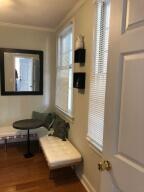 hallway featuring ornamental molding and hardwood / wood-style flooring