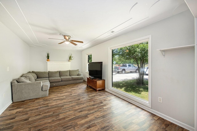 living area featuring visible vents, dark wood finished floors, ceiling fan, and baseboards