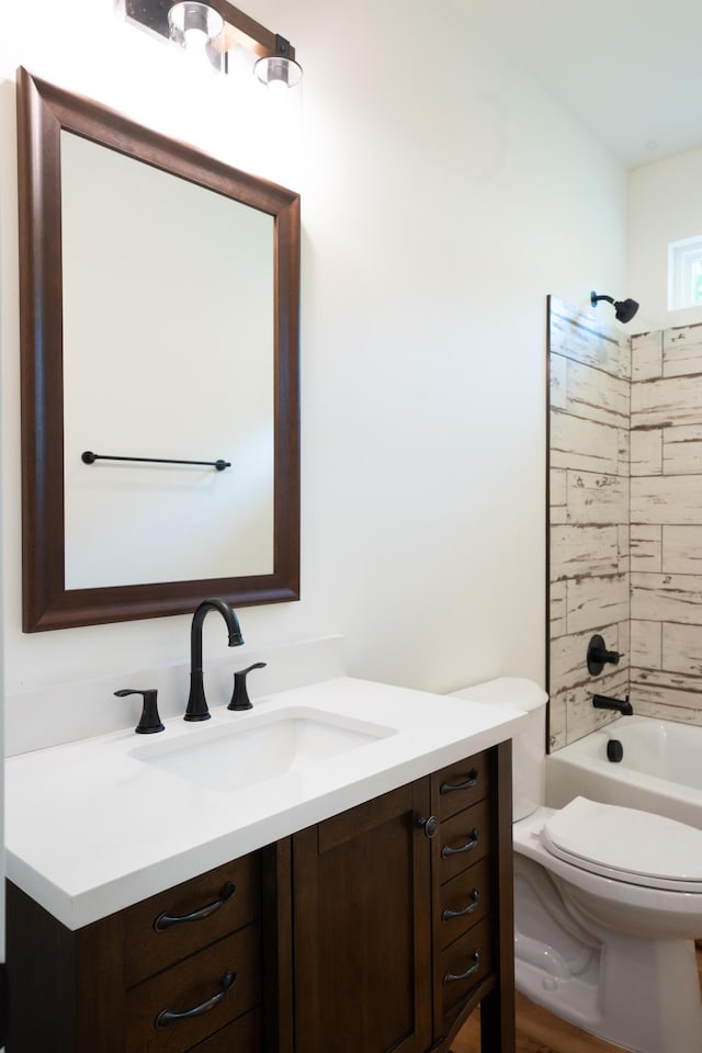bathroom with vanity, washtub / shower combination, and toilet