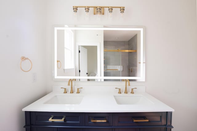 bathroom featuring double vanity, a sink, and a shower stall